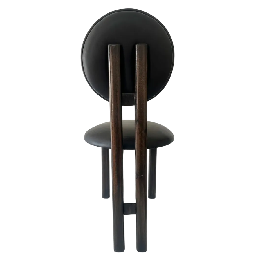 A modern dining chair with a circular black upholstered backrest, a matching cushioned seat, and four tapered dark wood legs, shown from the front on a white studio background.