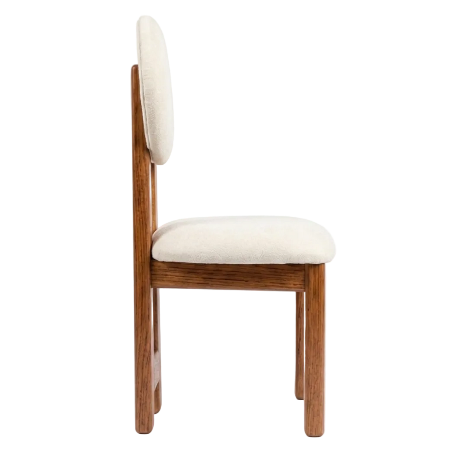 A mid-century modern style dining chair with a warm brown wood frame and cream-colored upholstered seat and backrest, shown from a side profile view against a solid white background.