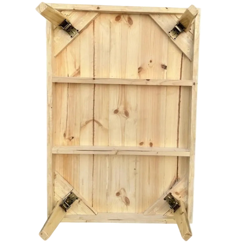 The underside of a wooden folding table, showing light natural wood planks, metal support brackets, and legs on a plain white background.
